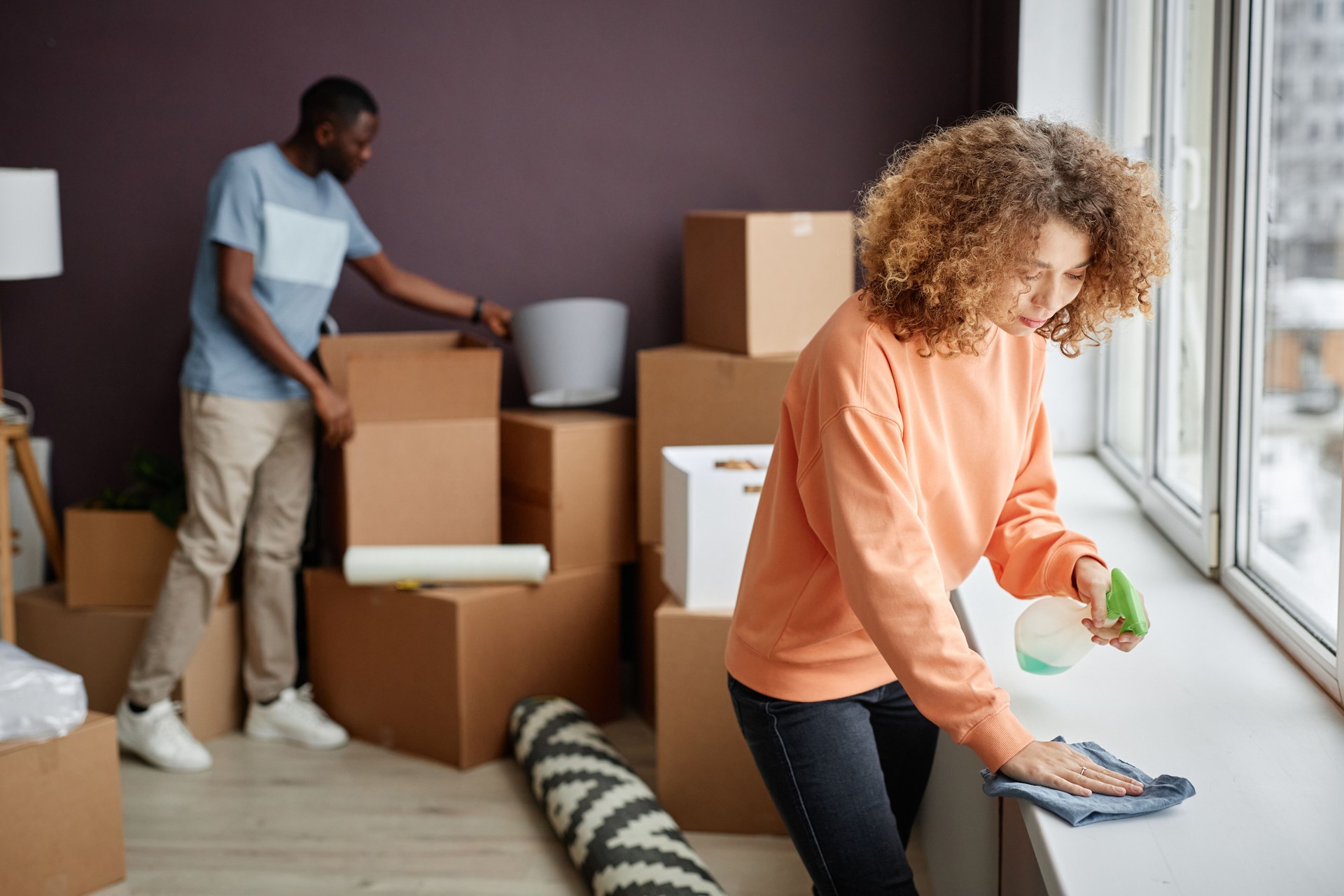 Young couple doing housework in the room